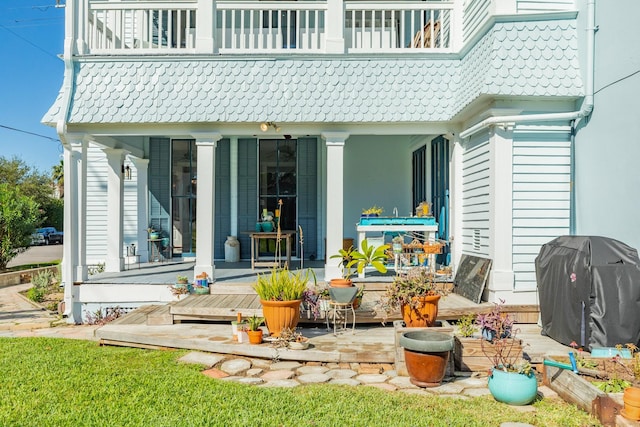 802 16th St, Galveston, TX 77550 - rear view of property featuring a balcony, a tiled roof, and a porch