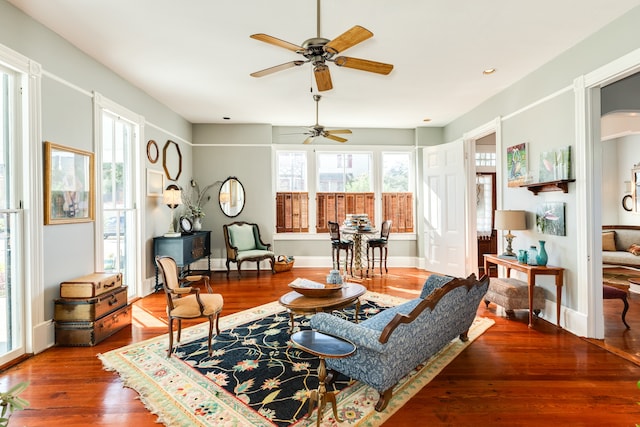 living area with ceiling fan and hardwood / wood-style flooring