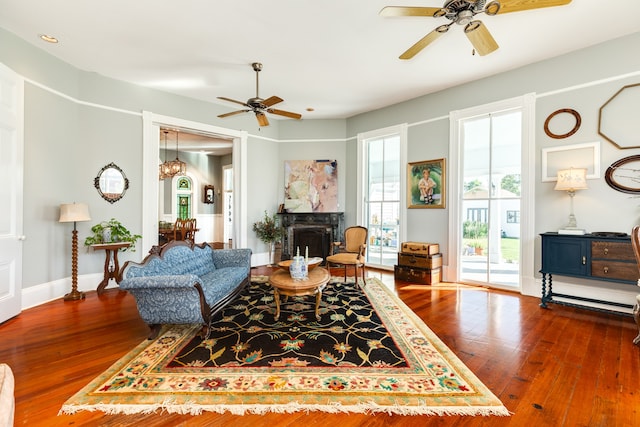 living room featuring hardwood / wood-style floors and ceiling fan