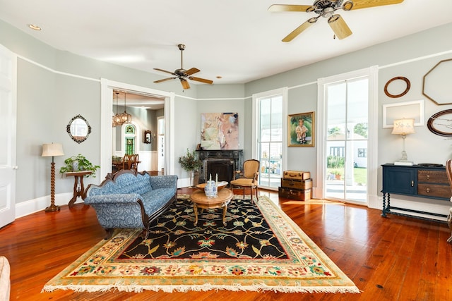 802 16th St, Galveston, TX 77550 - living room with a ceiling fan, hardwood / wood-style flooring, a fireplace, and baseboards
