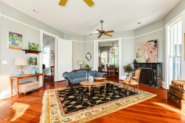 living room with ceiling fan and wood-type flooring