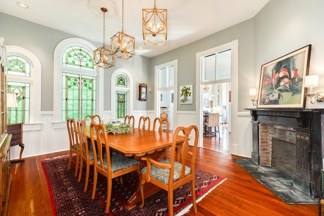 802 16th St, Galveston, TX 77550 - dining room with a chandelier, wainscoting, a brick fireplace, wood finished floors, and recessed lighting