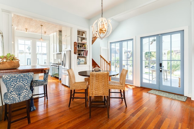 dining space featuring french doors, a healthy amount of sunlight, and wood-type flooring