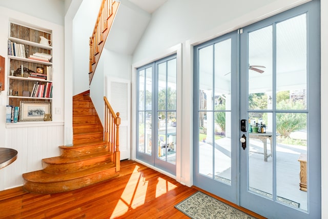 doorway featuring french doors, built in features, ceiling fan, and hardwood / wood-style floors