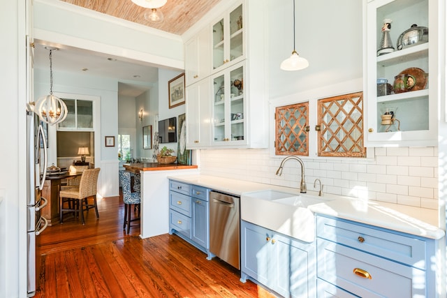 kitchen featuring dark hardwood / wood-style flooring, stainless steel appliances, pendant lighting, wooden ceiling, and white cabinetry