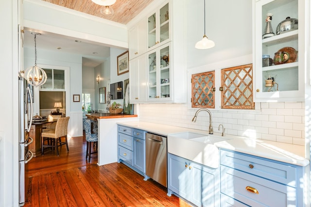 802 16th St, Galveston, TX 77550 - kitchen with a sink, stainless steel appliances, blue cabinets, dark wood-style floors, and pendant lighting