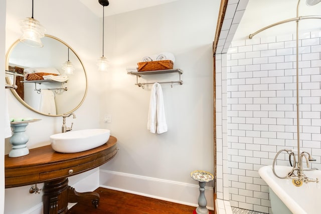 802 16th St, Galveston, TX 77550 - bathroom with a sink, a soaking tub, wood finished floors, a tile shower, and baseboards