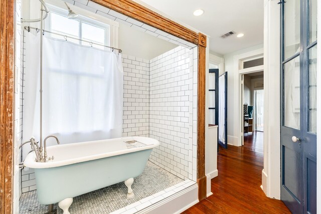 802 16th St, Galveston, TX 77550 - full bath featuring wood finished floors, a freestanding bath, and recessed lighting