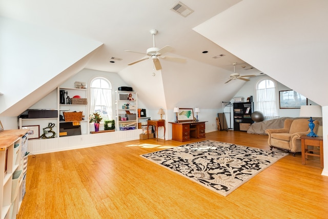 interior space featuring wood-type flooring, vaulted ceiling, and ceiling fan