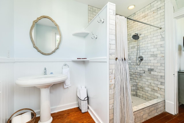 802 16th St, Galveston, TX 77550 - bathroom featuring tiled shower, wood finished floors, wainscoting, and a sink