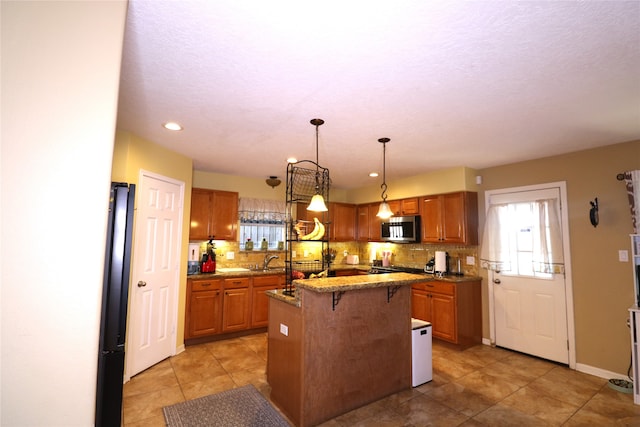 kitchen featuring decorative light fixtures, a kitchen island, a kitchen bar, and tasteful backsplash