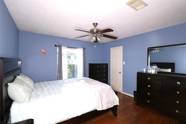 bedroom with dark hardwood / wood-style flooring and ceiling fan