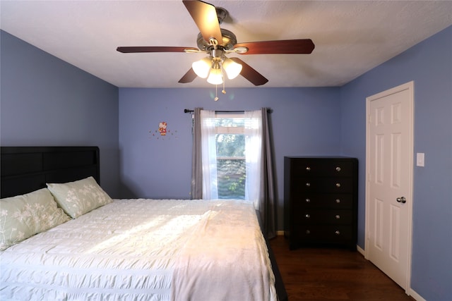 bedroom featuring dark hardwood / wood-style flooring and ceiling fan