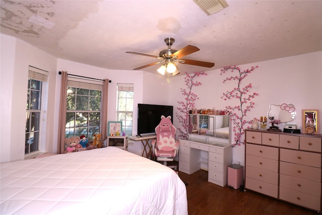 bedroom with ceiling fan and dark wood-type flooring