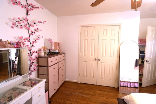 bedroom with dark hardwood / wood-style floors, a closet, and ceiling fan