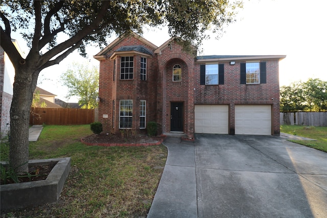 view of front of property with a garage and a front lawn