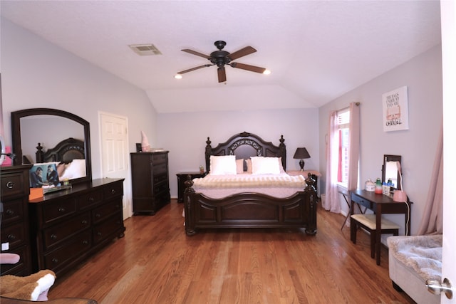 bedroom featuring hardwood / wood-style floors, ceiling fan, and vaulted ceiling