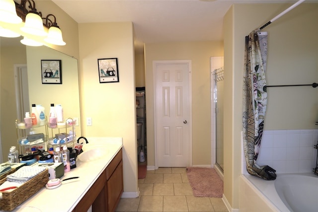 bathroom featuring tile patterned flooring, vanity, and shower with separate bathtub