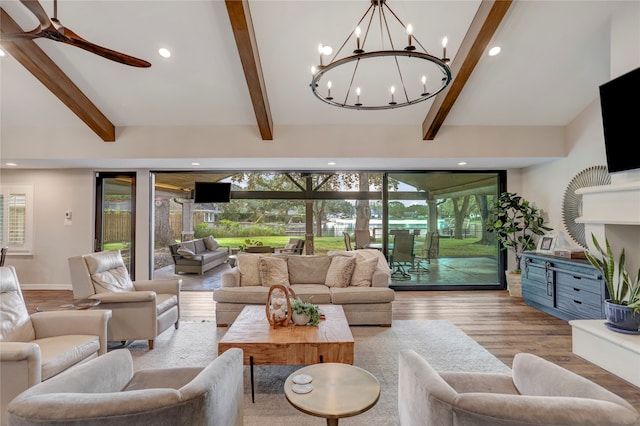 living room with vaulted ceiling with beams, light hardwood / wood-style floors, and ceiling fan with notable chandelier