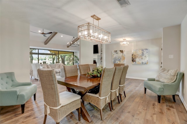 dining room with beamed ceiling, light hardwood / wood-style flooring, and ceiling fan