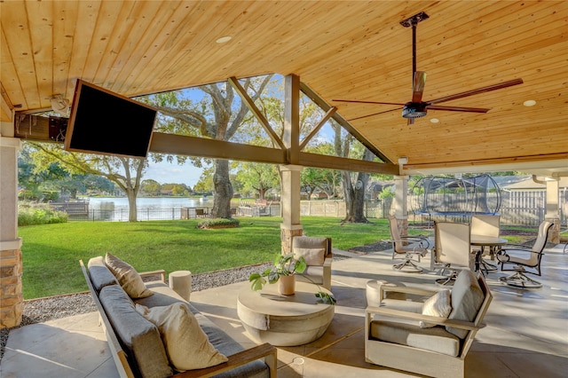 view of patio / terrace with ceiling fan, an outdoor hangout area, and a trampoline