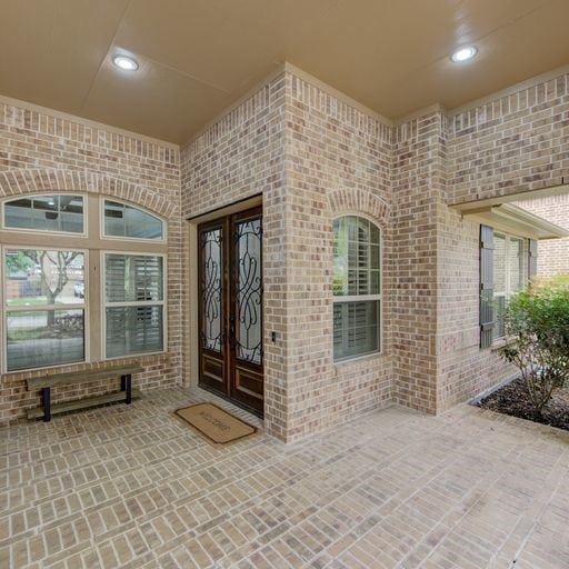 property entrance featuring french doors and a patio