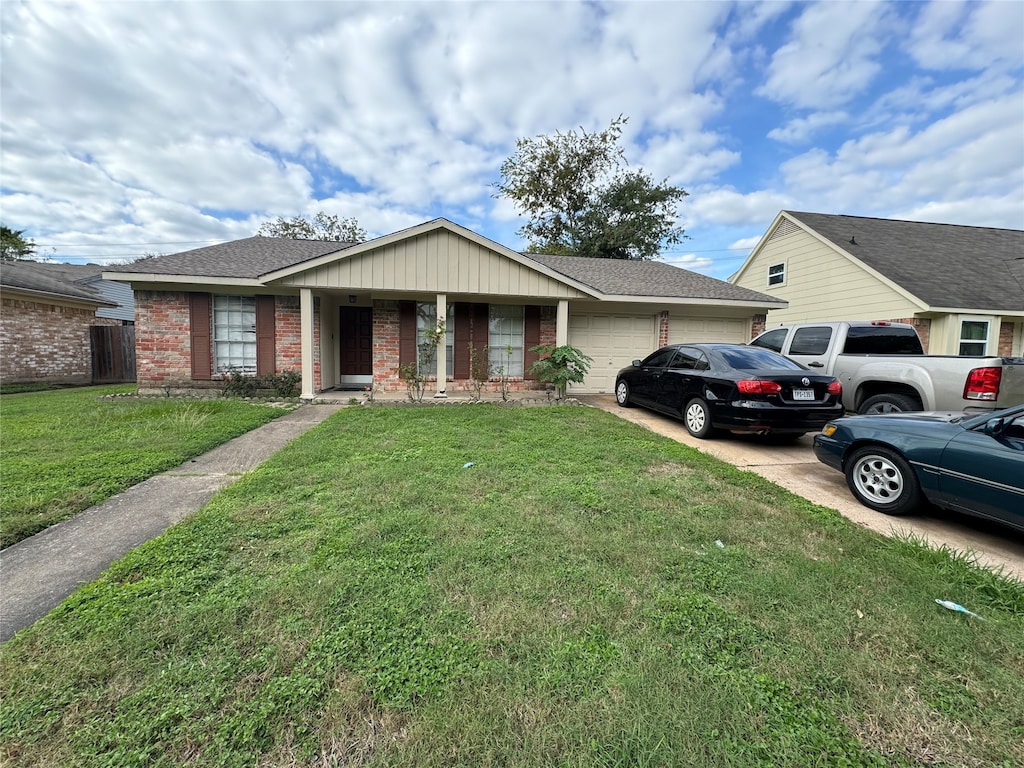 single story home with a front yard and a garage