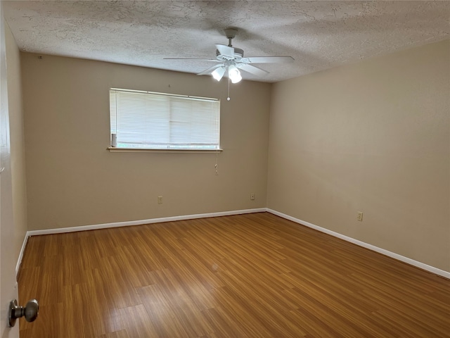 spare room featuring ceiling fan, wood-type flooring, and a textured ceiling