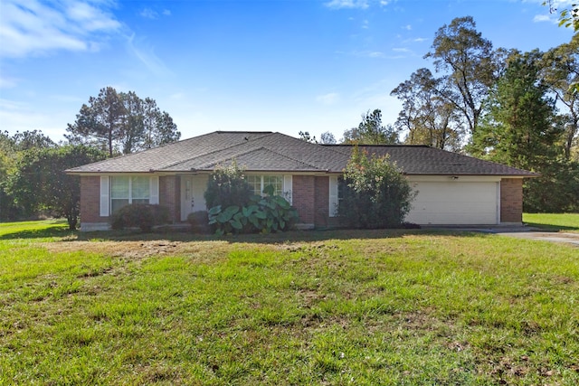 ranch-style house featuring a front yard and a garage