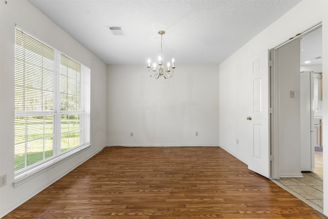 interior space featuring hardwood / wood-style flooring, a notable chandelier, and a wealth of natural light