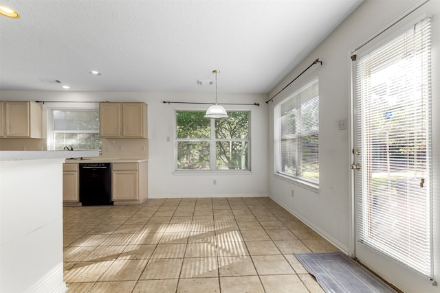 kitchen featuring dishwasher, light tile patterned floors, hanging light fixtures, and light brown cabinets