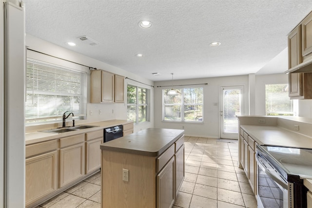 kitchen with pendant lighting, a center island, a healthy amount of sunlight, and sink