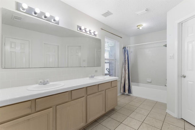 bathroom featuring decorative backsplash, shower / bath combination with curtain, a textured ceiling, vanity, and tile patterned flooring