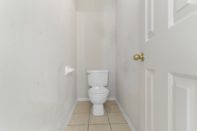 bathroom featuring tile patterned flooring and toilet