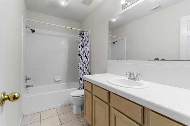 full bathroom featuring tile patterned flooring, a textured ceiling, toilet, decorative backsplash, and vanity