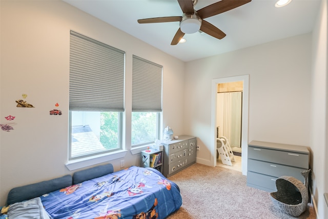 bedroom with ceiling fan and light colored carpet