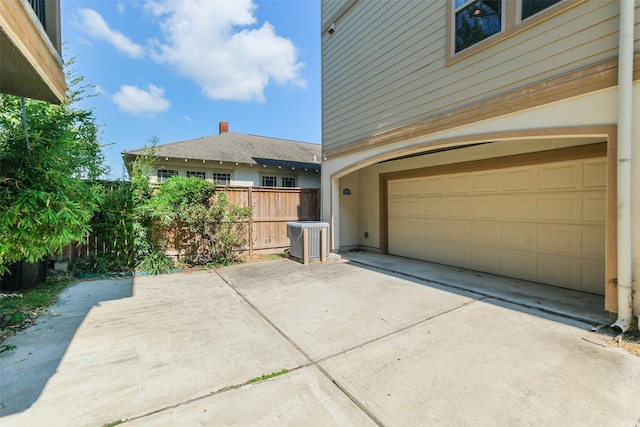 exterior space featuring a garage and central air condition unit