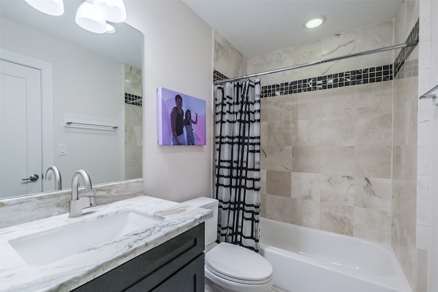 full bathroom with vanity, shower / bath combo, and toilet