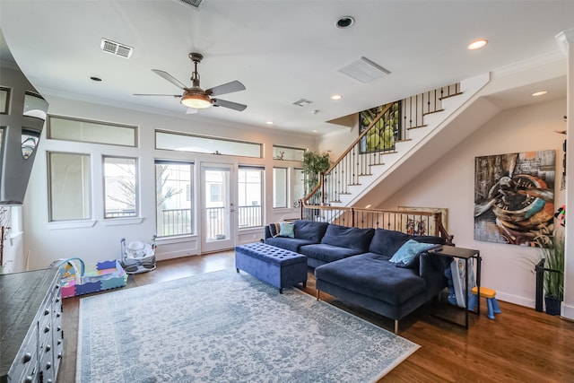 living room with dark hardwood / wood-style floors and ornamental molding