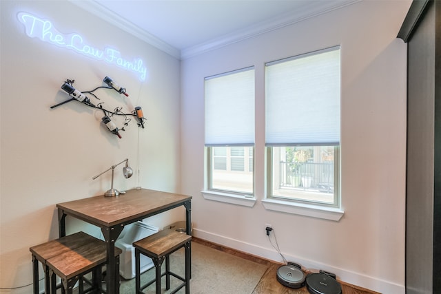 dining area featuring hardwood / wood-style flooring and ornamental molding