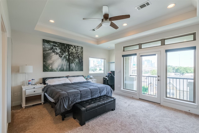 bedroom featuring access to outside, ceiling fan, a tray ceiling, and carpet