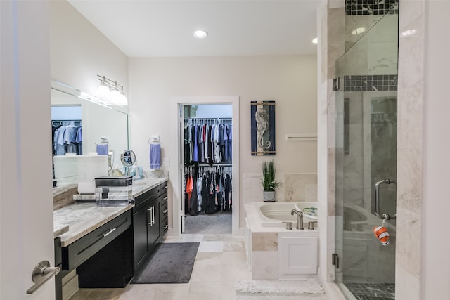 bathroom featuring tile patterned flooring, vanity, and independent shower and bath