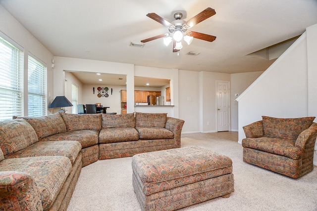 carpeted living room featuring ceiling fan