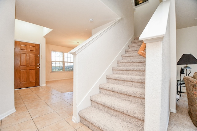 stairway with tile patterned flooring