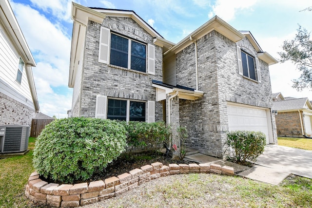 view of front of property featuring a garage and central air condition unit