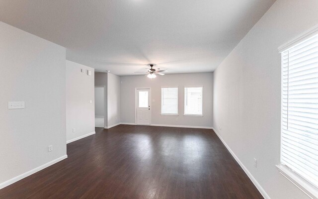 13101 Sapphire Lake Ln, Texas City, TX 77568 - spare room featuring ceiling fan, dark wood-type flooring, and baseboards