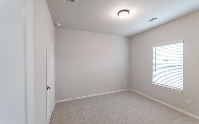 13101 Sapphire Lake Ln, Texas City, TX 77568 - spare room with light colored carpet, baseboards, a smoke detector, and a textured ceiling