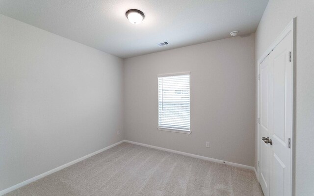 13101 Sapphire Lake Ln, Texas City, TX 77568 - empty room with light carpet, baseboards, and a smoke detector