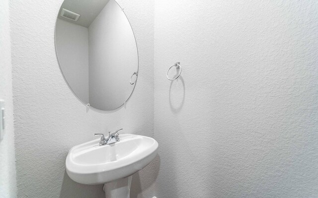 13101 Sapphire Lake Ln, Texas City, TX 77568 - bathroom with a sink and a textured wall