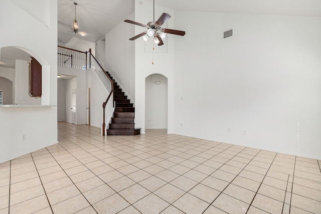 unfurnished living room featuring light tile patterned floors, high vaulted ceiling, and ceiling fan